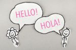 Pencil image of a woman saying hello in English and a man saying hello in Spanish