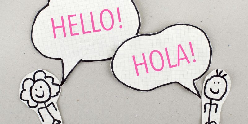 Pencil image of a woman saying hello in English and a man saying hello in Spanish
